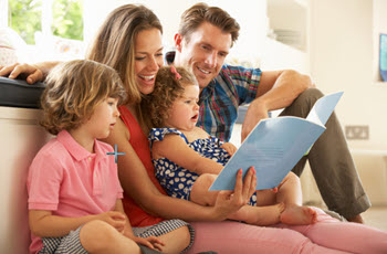 A happy family reading a book