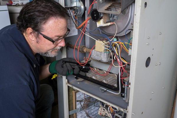 A technician fixing a propane unit