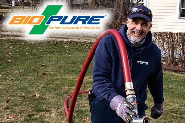 A man in work clothes holds a red hose, with the BioPure logo reading "BioPure: The Next Generation of Heating Oil" in the top left. 