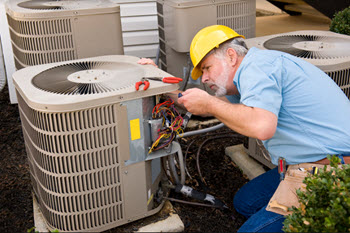 A technician repairing the HVAC unit