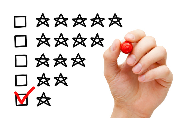 A hand is selecting a one-star rating on a checklist, which indicates the least positive customer feedback. 