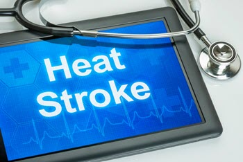 A close-up of a tablet with the text "Heat Stroke" displayed, along with a stethoscope lying on top. 