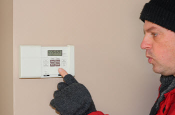 A man fixing the thermostat controller