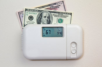 $100 bill and $50 bill on top of a thermostat