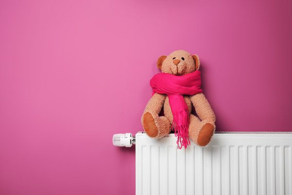 A teddy bear with a pink scarf 