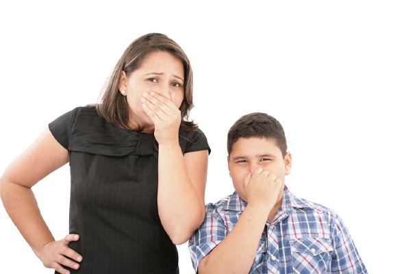 A woman and a child are holding their noses 