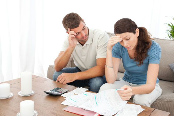 couple looking at energy costs and high cost of electrification