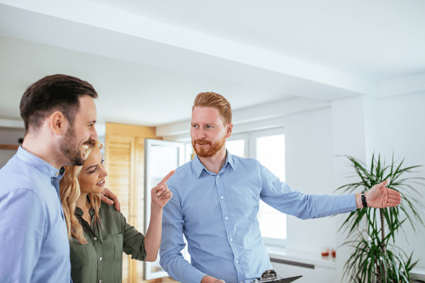 couple with realtor depicting home comfort of potential house