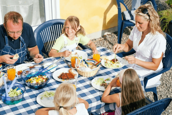 family dining al fresco to keep cool naturally in summer