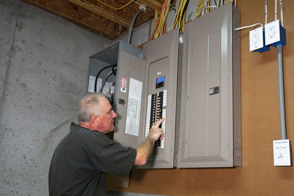 image-of-homeowner-at-circuit-breaker-box-after-furnace-blows-circuit