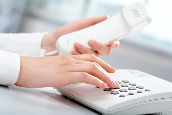 a woman using telephone