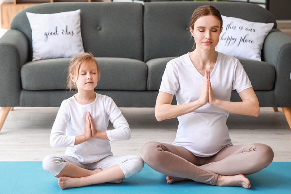 mother and daugther doing yoga