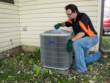 Townsend Energy technician inspecting an outdoor AC unit