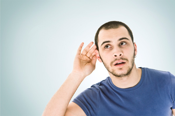 image of a homeowner listening for hissing coming from air conditioner