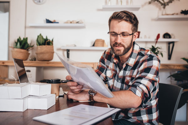 image of homeowner reading hvac warranty paperwork