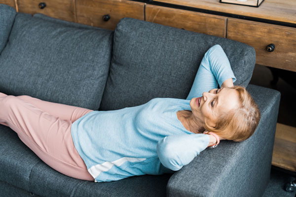 senior woman enjoying comfort of new AC unit