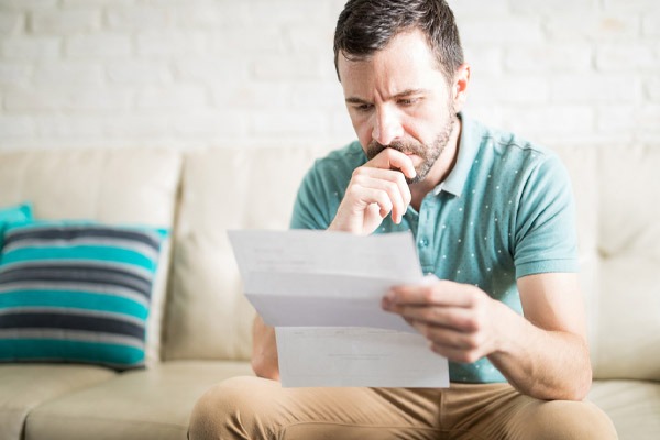 image of a man calculating home cooling costs and expense