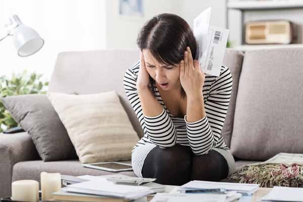 woman calculating fuel costs of a power generator