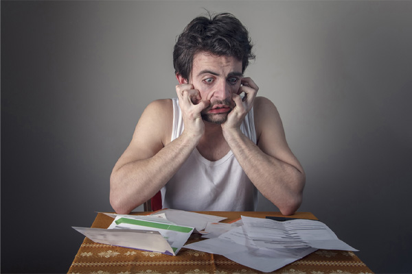 image of homeowner shocked at high summer energy bills