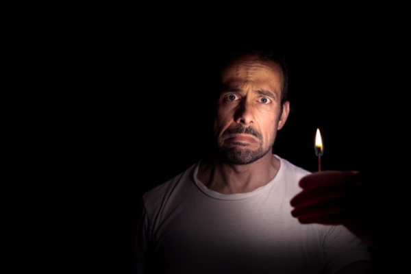 image of man with a worried face holding a matchstick depicting generator won't start