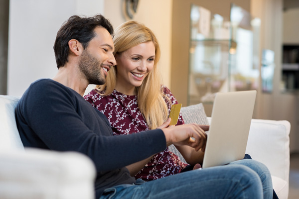 happy couple looking at home heating costs