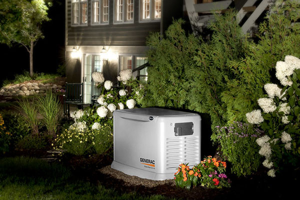 generac generator installed outside the home surrounded by plants and flowers with sufficient airflow