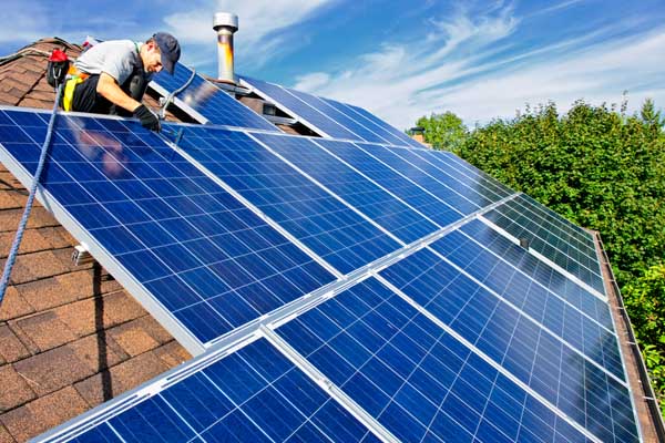 technician installing solar panels