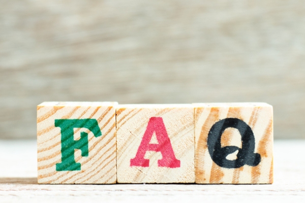 FAQ painted on wooden blocks depicting questions about heating system repair or replacement