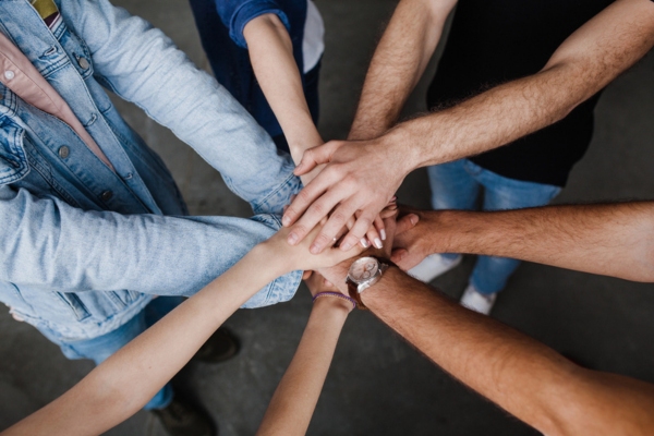 team put hands together depicting whole-house generator components working together