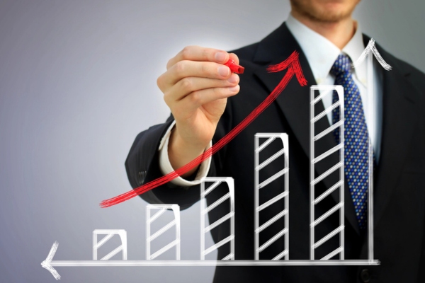 businessman showing growth graph depicting economic development