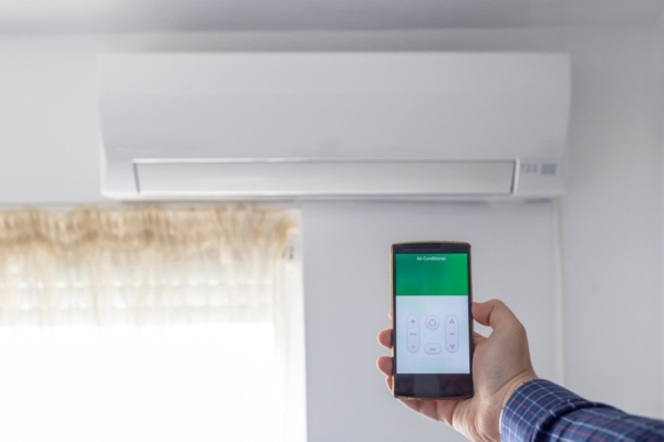 smart phone controlling ductless air conditioner depicting advancement in air conditioner technology