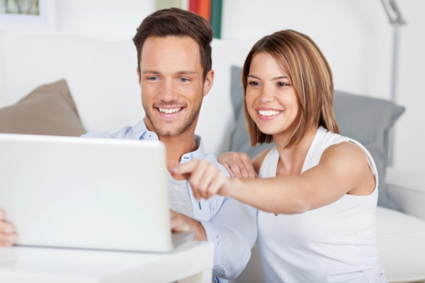 young couple reading from laptop depicting value of being informed about propane benefits