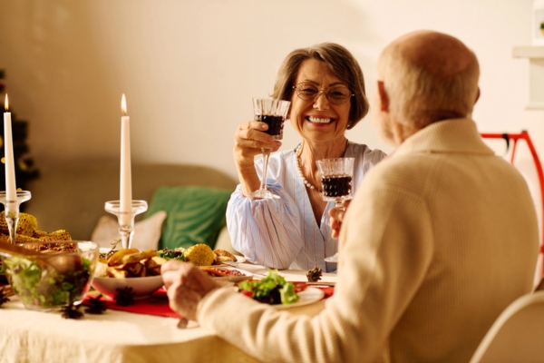 elderly couple enjoying a dinner date at home during winter