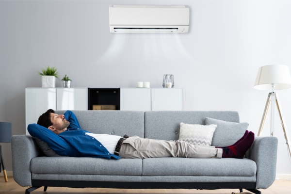 man keeping warn while napping on the couch with ductless mini-split heating