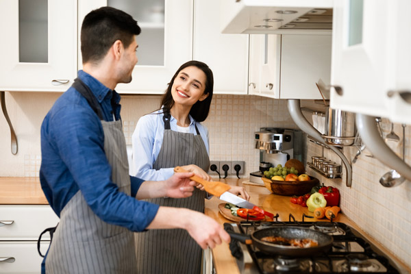 couple cooking on propane stove depicting propane gas versatility