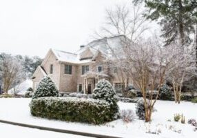 brick house after a heavy snow